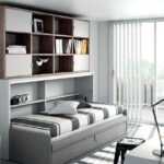 Cama abatible con sofá y armario librería.